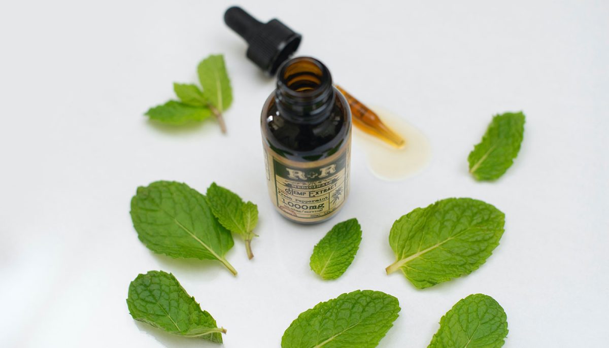 fresh peppermint essential oil and leaves
