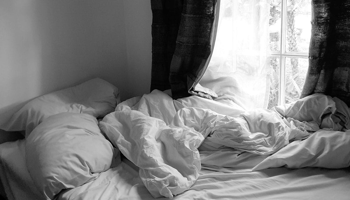 bed with blanket and pillows